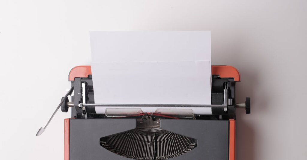 From above crop person using vintage black and red typewriter with white blank sheet of paper against white background