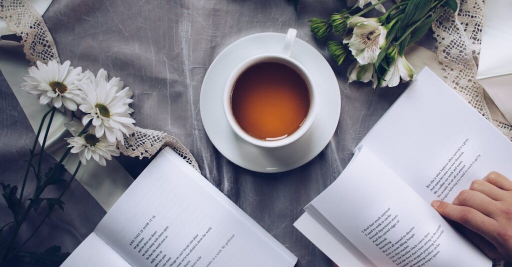 White Ceramic Teacup With Saucer Near Two Books Above Gray Floral Textile